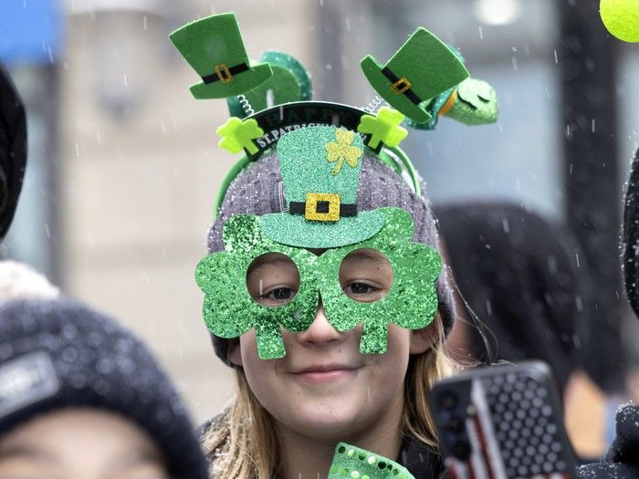 A spectator braves the steady snowfall to watch the St. Patrick’s Parade in Montreal on Sunday, March 22, 2026. A spectator braves the steady snowfall to watch the St. Patrick’s Parade in Montreal on Sunday, March 22, 2026.