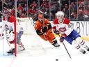 Canadiens' Kaiden Guhle (21) controls the puck past Cutter Gauthier of the Anaheim Ducks during the second period at the Honda Center on Friday, March 6, 2026, in Anaheim, Calif.