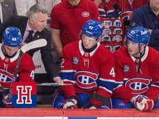 Canadiens head coach Martin St. Louis gives instructions to Adam Engstrom and Noah Dobson, far right, as fellow defenceman Lane Hutson consults a tablet during third period against the Philadelphia Flyers in Montreal on Dec. 16, 2025.
