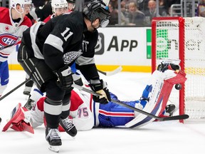 Hockey goaltender flops on the ice to stop a shot.
