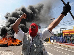 A supporter of ousted Honduran President Manuel Zelaya protests against the coup d'etat in the surroundings of the presidential house in Tegucigalpa last year.