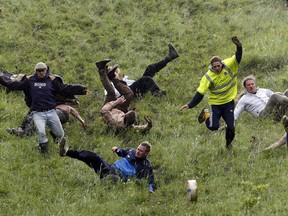 Competitors take part in the Cheese Rolling event on Coopers Hill in Gloucester, southern England in 2007.