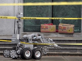 A bomb squad robot investigates two suspicious packages left on the front doors of the Bank of Canada in Ottawa in 2008.