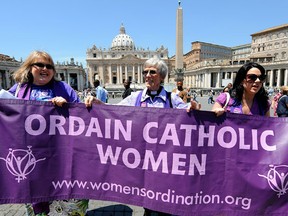 Activists of the U.S. Women's Ordination Advocates organization hold a banner during their vigil, calling Pope Benedict XVI to ordain women, in St.Peter's square at the Vatican.