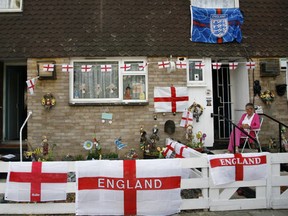 England flags adorn a house in south west London June 17, 2010. England are due to play Algeria in their 2010 World Cup Group C soccer match in South Africa on Friday