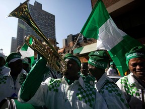 Nigerian supporters, carrying a national flag (but no chicken), parade through Johannesburg with drums and trumpets toward the Ellis park stadium, where the 2010 Football World Cup match between Nigeria and Argentina takes place on June 12, 2010.