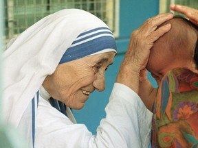 Mother Teresa blessing a child at the Gift of Love Home in Singapore on October 20, 1993.