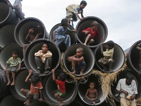 Children play in water pipes at a construction site on the banks of the Yamuna River in the northern Indian city of Allahabad in July.