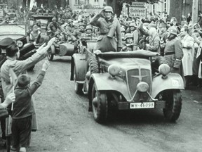 German soldiers are greeted with Nazi salutes from civilians as they enter Czechoslovakia in 1938.