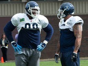 Newly acquired defensive tackle Walter Curry, left, and defensive end Ricky Foley chat during Toronto Argonauts practice at Sir Robert L. Borden Business and Technical Institute in Scarborough, Ont., Sept. 15, 2010.