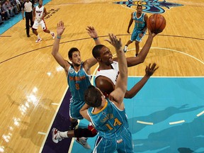 Chris Bosh of the Miami Heat shoots the ball over Jason Smith of the New Orleans Hornets at the New Orleans Arena on October 13, 2010 in New Orleans.