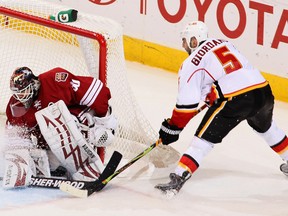 Mark Giordano of the Calgary Flames scores a second period goal past goaltender Ilya Bryzgalov of the Phoenix Coyotes during the NHL game at Jobing.com Arena on January 28, 2010 in Glendale, Arizona.