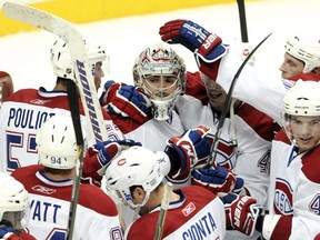 The Montreal Canadiens congratulate their goaltender Carey Price after beating the Pittsburgh Penguins in their NHL hockey game at the Consol Energy Center in Pittsburgh, Pennsylvania October 9, 2010.