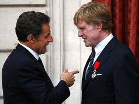 Actor and Director Robert Redford (R) receives the Knight of the Legion of Honor from France's President Nicolas Sarkozy during a ceremony at the Elysee Palace in Paris, October 14, 2010.