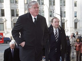 Gary Bettman (R), commissioner of the NHL, and Brian Burke, general manager of the Toronto Maple Leafs, attend the funeral of former NHL coach Pat Burns in Montreal November 29, 2010.