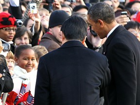 WASHINGTON, DC - JANUARY 19: (AFP OUT) Sasha Obama (L), the younger daughter of U.S. President Barack Obama (R), greets Chinese President Hu Jintao (C) during a state arrival ceremony at the South Lawn of the White House January 19, 2011 in Washington, DC. Hu and President Obama will hold a press conference at the White House later today.  (Photo by Alex Wong/Getty Images)