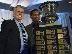 Toronto Argonauts coach Jim Barker, left, stands with player Jeremaine Copeland after Barker was named Canadian Football Leagues Coach of the Year during a ceremony in Vancouver, British Columbia February 25, 2011.
