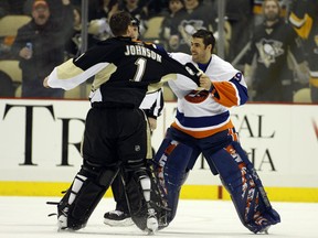 Rick DiPietro (R) of the New York Islanders mixes it up with Brent Johnson of the Pittsburgh Penguins at Consol Energy Center on February 2, 2011 in Pittsburgh. Johnson won by KO.