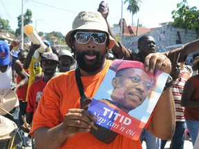 Supporters of ex-Haitian president Jean-Bertrand Aristide prove that even dictators can have fans.