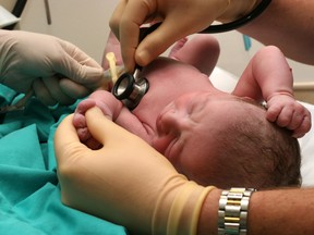 New born baby being examined by doctor