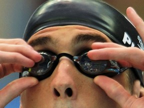 Michael Phelps of the U.S. adjusts his goggles.