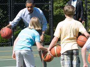 US President Barack Obama plays basketball with kids.