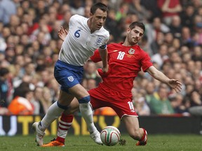 England's John Terry challenges Wales' Ched Evans (R) during their Euro 2012 Group G qualifying soccer match at the Millennium Stadium in Cardiff, south Wales.