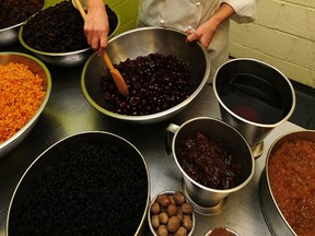 FLECKNEY, UNITED KINGDOM - MARCH 24: Cake designer Fiona Cairns, who has been commissioned by Prince William and Kate Middleton to create a multi-tiered traditional fruit cake for their wedding, mixes ingredients, on March 24, 2011