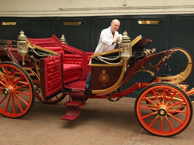 Carriage Restorer Dave Evans cleans the 1902 State Landau carriage at the Royal Mews in central London, on March 21, 2011.  