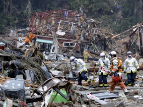 Rescue personnel search for missing residents in Minamisanriku, Miyagi prefecture on March 15, 2011, following a massive earthquake and tsunami on March 11.