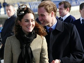 Britain's Prince William (R) accompanied by his fiancee Kate Middleton (L) is pictured during a visit to RNLI Lifeboat Station in Anglesey, near Bangor in Wales on February 24, 2011.