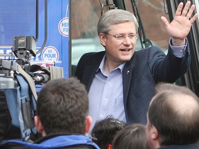 Canadian Prime Minister Stephen Harper waves to supporters and members of the media after he spoke with Vaughan, Ontario residents.