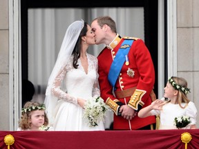 Britain's Prince William and his wife Catherine, Duchess of Cambridge kiss on the balcony of Buckingham Palace.