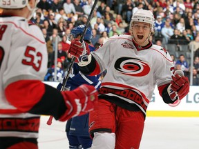 Jussi Jokinen of the Carolina Hurricanes congratulates teammate Jeff Skinner on his goal in a game against the Toronto Maple Leafs on December 28, 2010 at the Air Canada Centre in Toronto, Ontario.