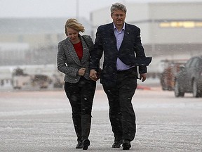 Stephen Harper walks to his campaign plane with his wife Laureen in Charlottetown, Prince Edward Island April 1, 2011