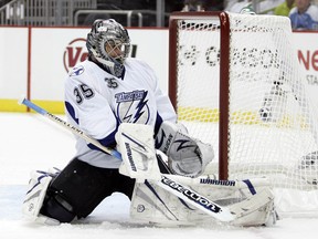 Dwayne Roloson of the Tampa Bay Lightning makes a save against the Pittsburgh Penguins in Game Seven of the Eastern Conference Quarterfinals during the 2011 NHL Stanley Cup Playoffs at Consol Energy Center on April 27, 2011 in Pittsburgh, Pennsylvania.