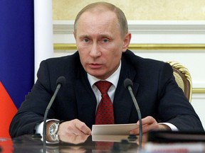 Russian Prime Minister Vladimir Putin (L) chairs a meeting on the 2018 World Cup in Moscow, on April 6, 2011.