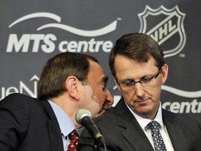 NHL Commissioner Gary Bettman (L) talks with True North Sports and Entertainment Chairman Mark Chipman as they attend a news conference in Winnipeg, Manitoba, May 31, 2011.Canada reclaimed one of its lost NHL franchises on Tuesday when the Atlanta Thrashers were sold to True North Sports and Entertainment and relocated to Winnipeg, triggering wild celebrations in the Prairie city.