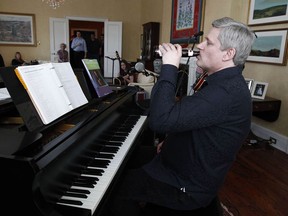 Former Prime Minister Stephen Harper sips a beer while practicing with his band "Herringbone" at 24 Sussex Drive,one of the historic moments associated with the prime ministerial residence.
