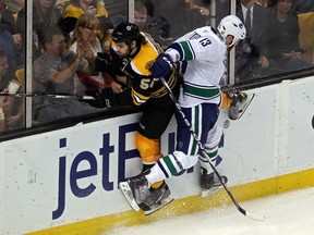 Adam McQuaid gets checked by Raffi Torres during Game Four of the 2011 NHL Stanley Cup Final