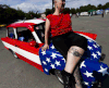 Fans and owners of East German-era Trabant cars gather at the 2011 International Trabantfahrer Treffen on Jun. 25, 2011 in Zwickau, Germany.A woman is shows posing a tatoo of a Trabant on their leg