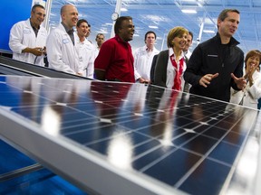 Former Ontario Premier Dalton McGuinty tours the solar panel assembly line at the Eclipsall Energy Corp. manufacturing facility during a campaign stop in Scarborough, Ont.