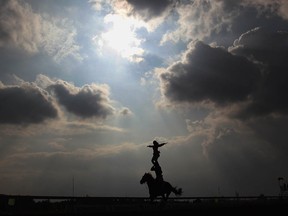 GUIYANG, CHINA - SEPTEMBER 12:  Runners pass the grandstand during the 9th National Traditional Games of Ethnic Minorities of the People's Republic of China on September 12, 2011 in Guiyang, China.  (Photo by Feng Li/Getty Images)