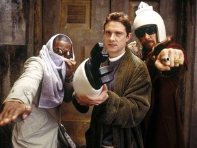 In Hitchhiker's Guide to the Galaxy, Ford Prefect, here played by Mos Def (left), changes the entry on Earth from "Harmless" to "Mostly harmless."