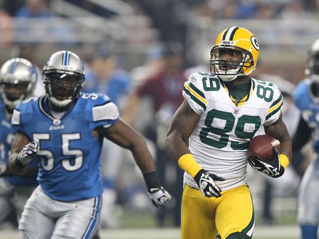 Green Bay Packers B.J. Raji is   hit for his touchdown dance