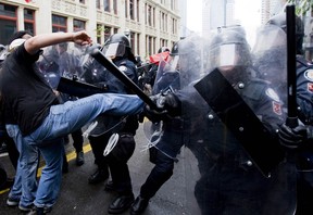 Demonstrators clash with police at the corner of Queen Street West and John Street as the G20 summit begins in Toronto, Saturday, June 26, 2010.