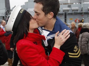 Leading Chef Matthew Jones from HMS Liverpool kisses his girlfriend Sophie Bates after the ship returned to it's base in Portsmouth, southern  England November 7, 2011.  The warship returned home to Portsmouth on Monday after more than seven months working as part of NATO operations off the coast of Libya.   REUTERS/Eddie Keogh (BRITAIN - Tags: MILITARY SOCIETY)