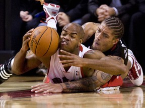 Raptors guard  Jarrett Jack (left) battles for a loose ball with Heat forward Michael Beasley in the first half as the Toronto Raptors take on the Miami Heat, Friday night, November 20, 2009 at Air Canada Centre in Toronto.
