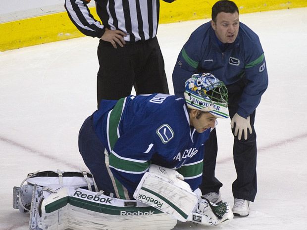 Gay couple get married in pro hockey arena, with a priest referee