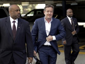 British talk show host Piers Morgan and former News of the World editor arrives for work at CNN after his British judicial inquiry in Los Angeles, California December 20, 2011. Morgan told a British judicial inquiry on Tuesday that he had never approved phone hacking during his time as a tabloid newspaper editor, and that his published boasts had merely been repeating rumours about journalistic "dark arts".    REUTERS/Gus Ruelas (UNITED STATES - Tags: CRIME LAW MEDIA TPX IMAGES OF THE DAY)